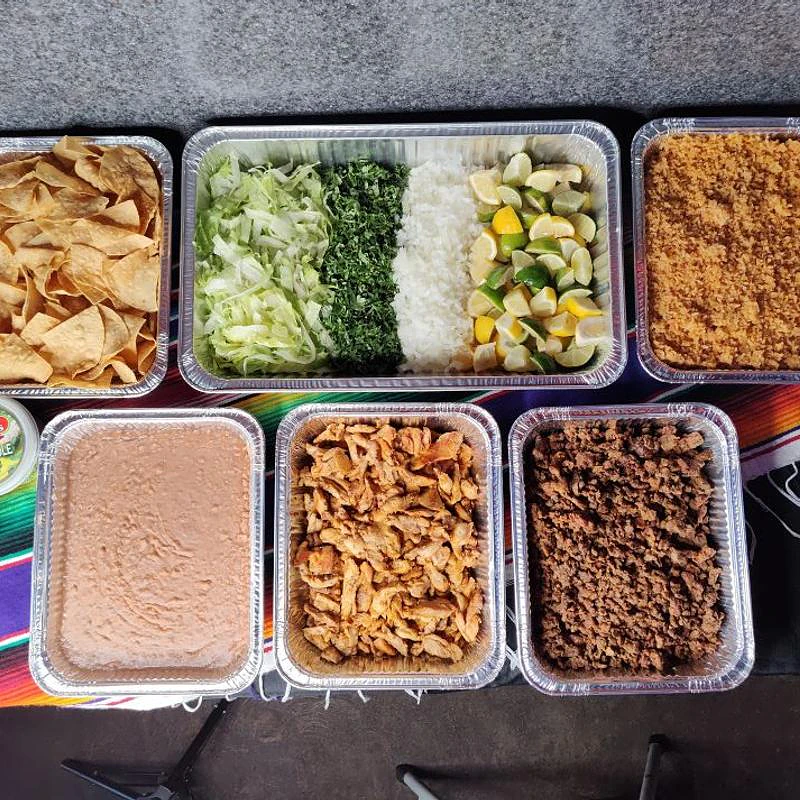 Bobby’s hot taco bar with trays of meat, rice, beans and toppings
